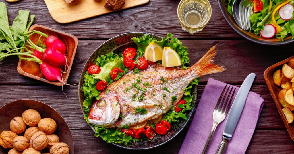Healthy Malaysian meal spread with fish, salad and vegetables on a table
